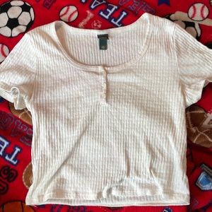 This is a cream colored blouse, it has buttons on the front that are real.